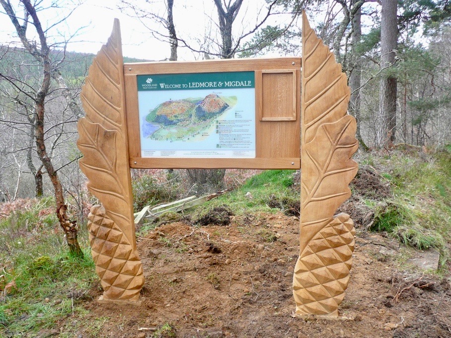ledmore and migdale wood carved information sign wildchild designs